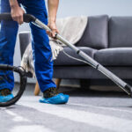 Photo Of Janitor Cleaning Carpet With Vacuum Cleaner
